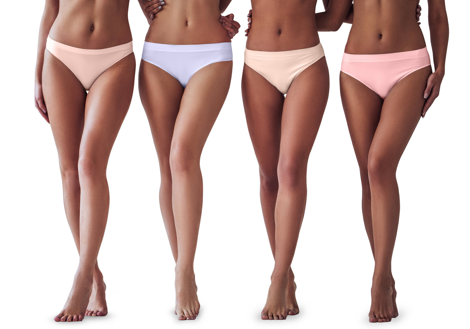 Four women standing side by side, wearing seamless underwear in pastel shades of pink, lavender, and beige, shown from shoulders down, barefoot against a white background.
